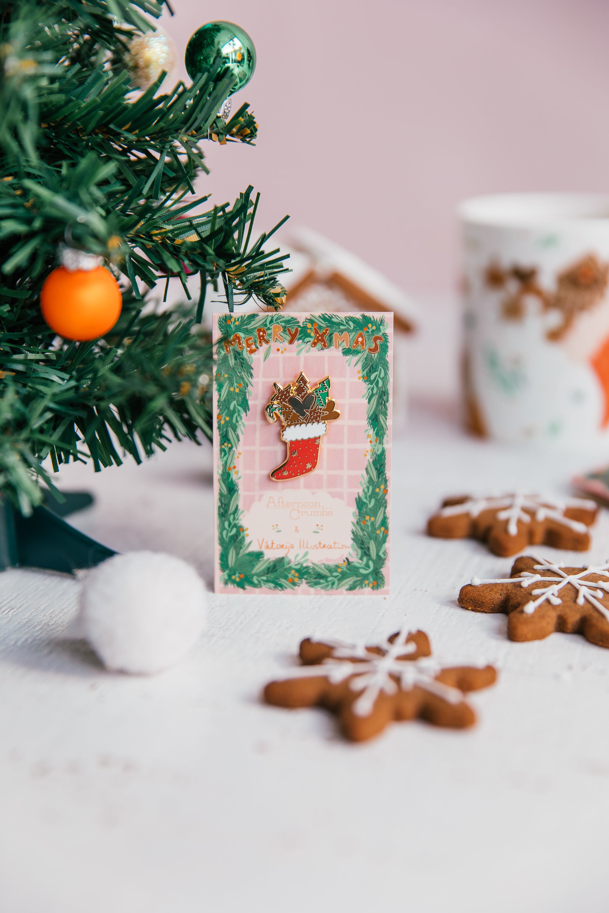 Enamel Christmas Stocking Pin next to Christmas Tree