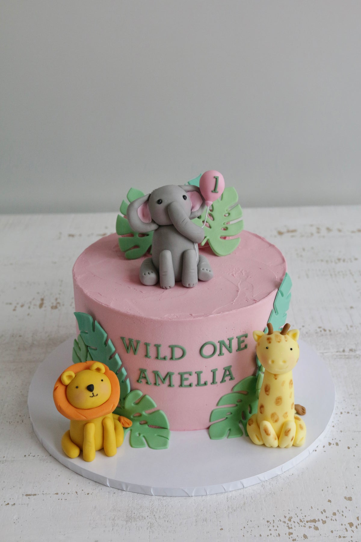 Pink Buttercream Wild One 1st Birthday Jungle Safari Cake with Elephant, Lion & Giraffe