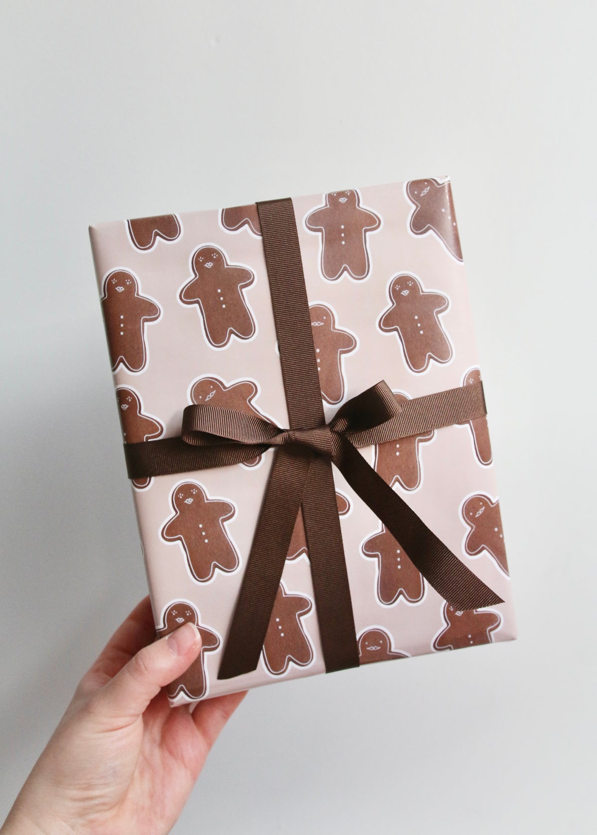 Gingerbread Man & Woman Christmas Wrapping Paper Holding Boxed Present