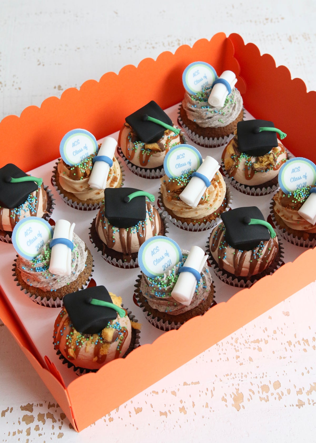 Box of Graduation Cupcakes with caps and scrolls