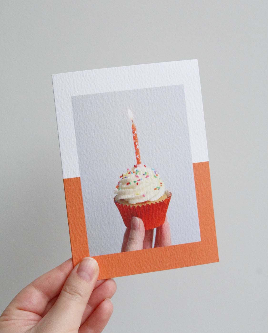 Birthday card with photo of a cupcake in an orange case with an orange candle