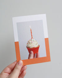 Birthday card with photo of a cupcake in an orange case with an orange candle
