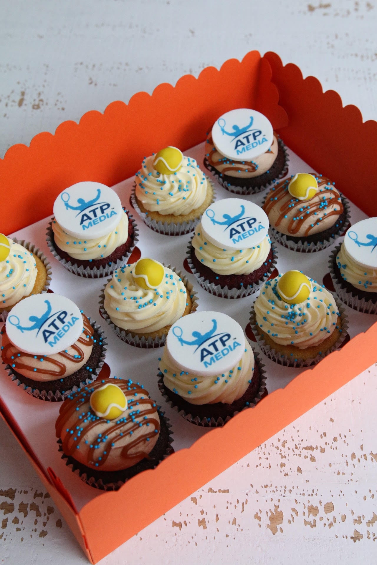 Box of ATP Media Logo and Tennis Ball Cupcakes