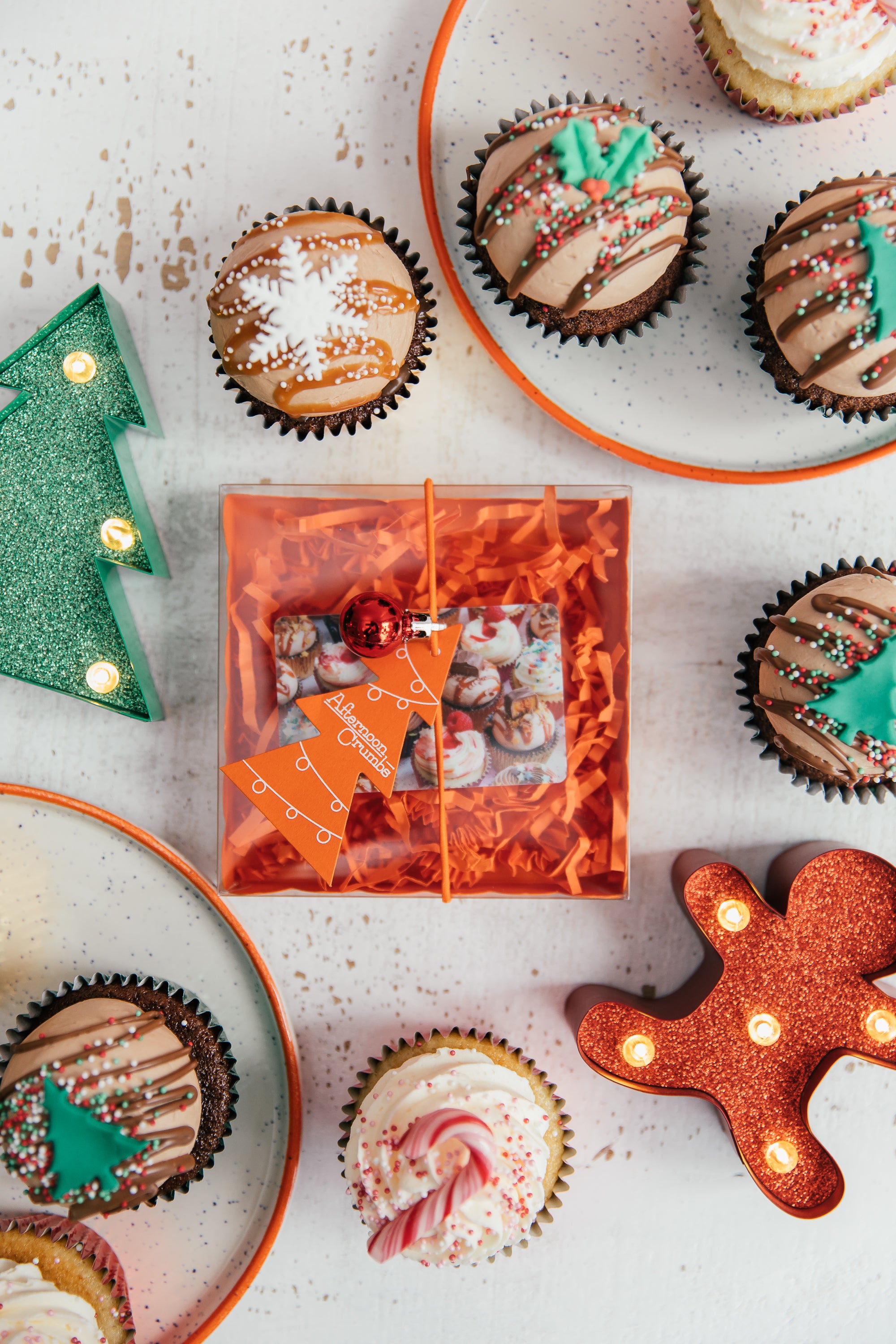 Afternoon Crumbs Physical Gift Card with Christmas Gift Packaging on table with cupcakes