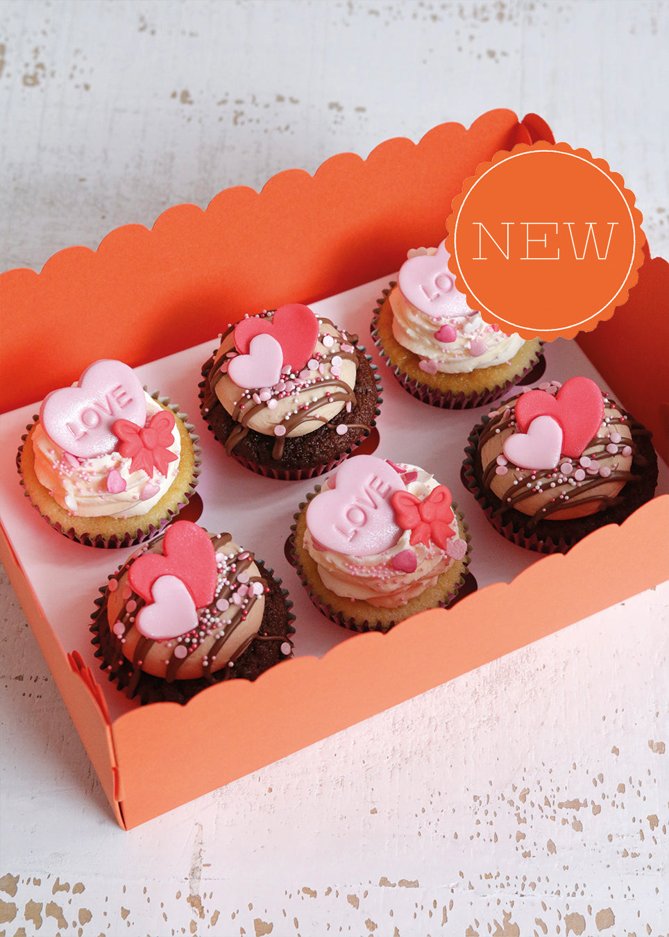 Box of Valentine's Vanilla & Chocolate Cupcakes with Pink & Red Heart & Bow Decorations with a NEW Badge