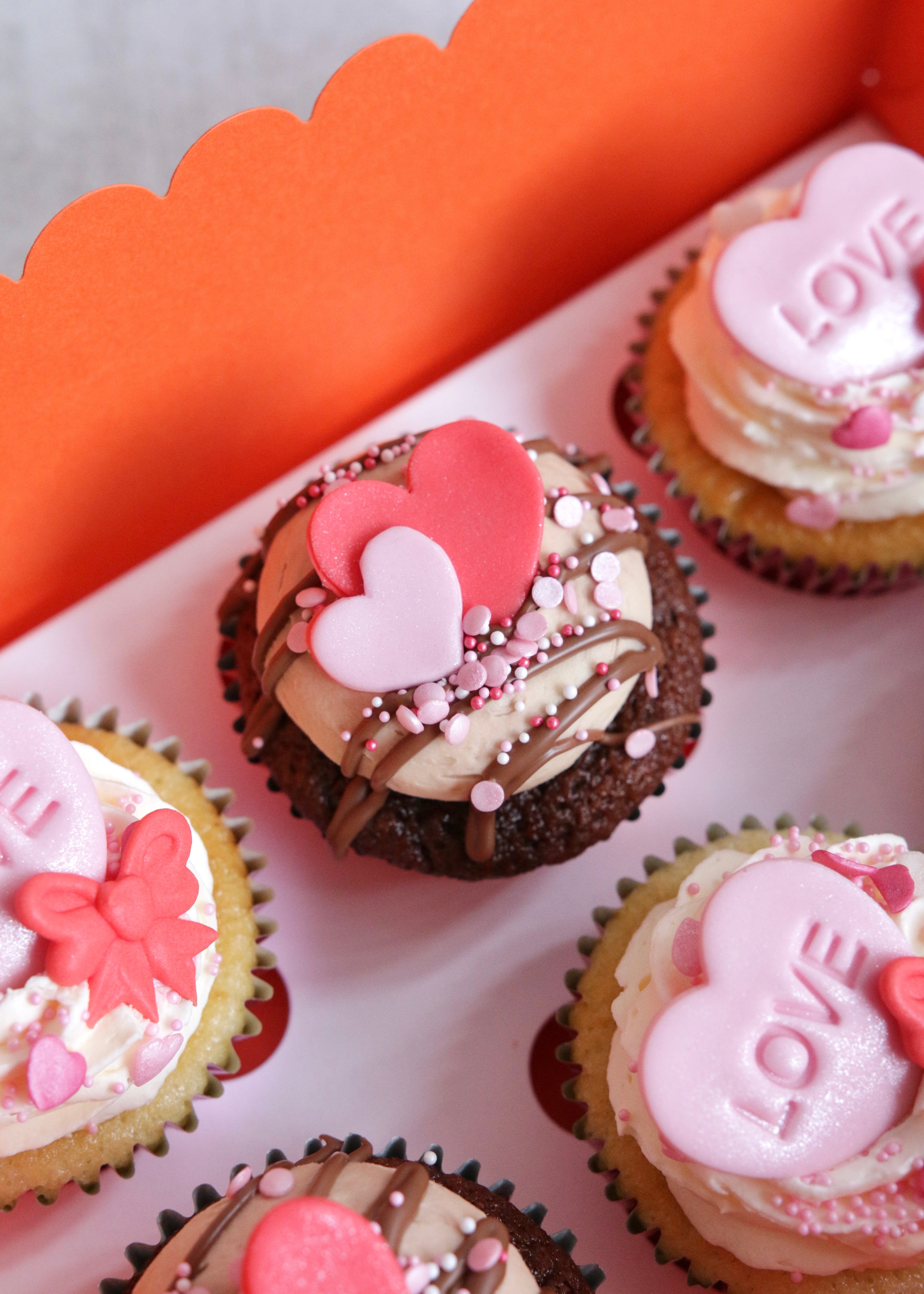 Close Up on Chocolate Valentine's Cupcake in Box with Red & Pink Heart Decoration