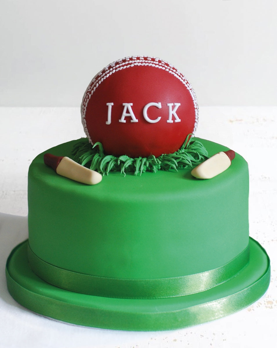 Green Fondant Cake with Cricket Ball Decoration and Bats on Top