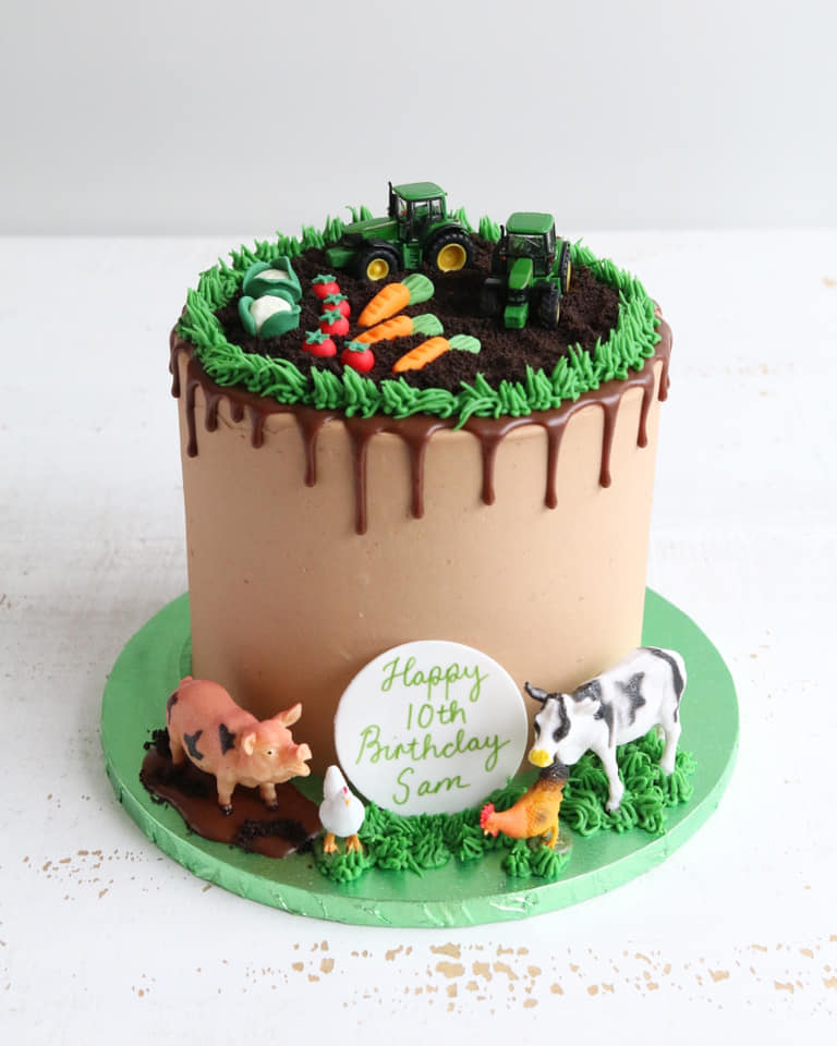 Chocolate Buttercream Cake with Chocolate Drip, Toy Farm Animal Decorations round the bottom and Oreo 'dirt' with fondant vegetable patch and toy tractors on top