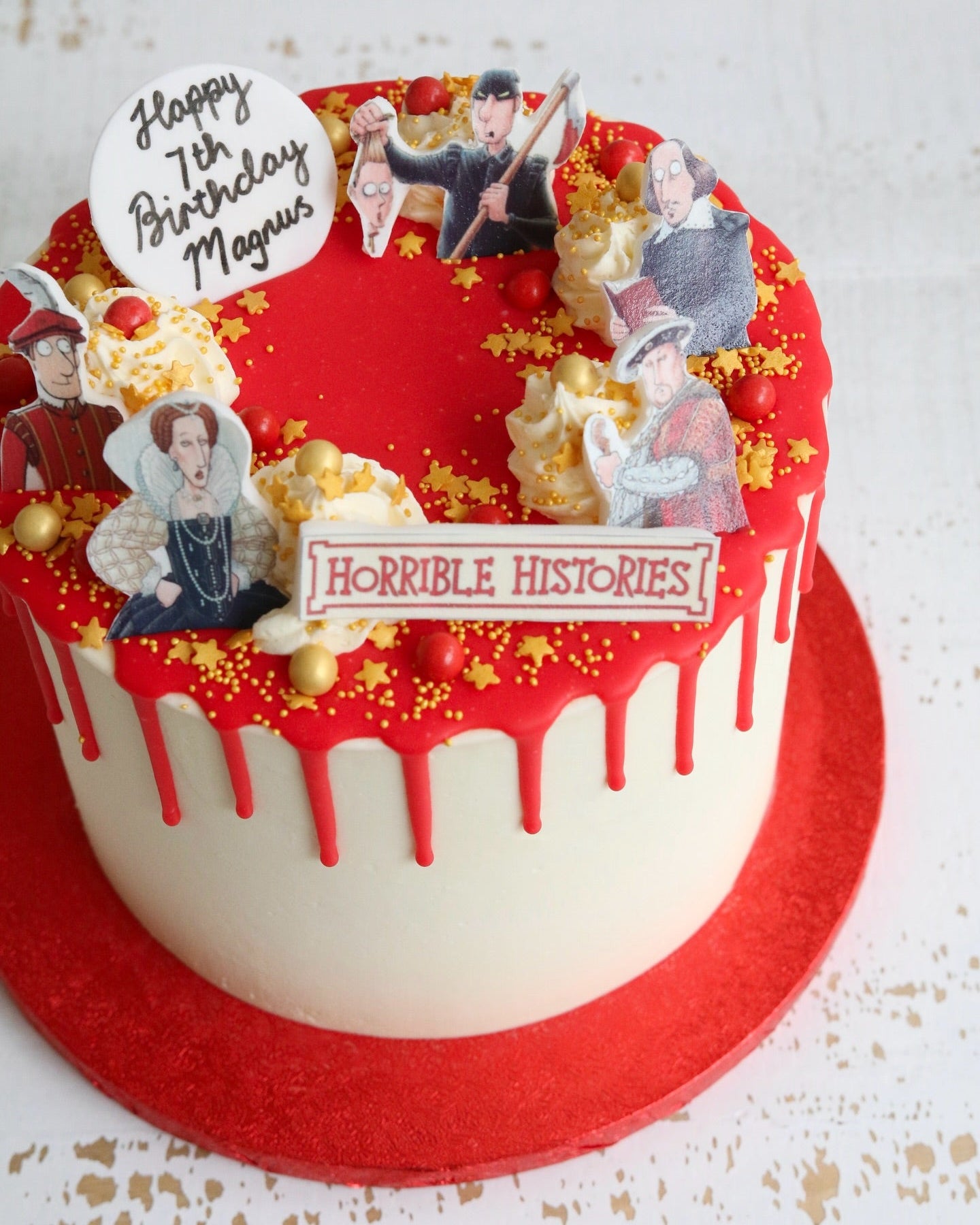 Horrible Histories 7th Birthday Cake with Printed Characters, Logo and Red Drip