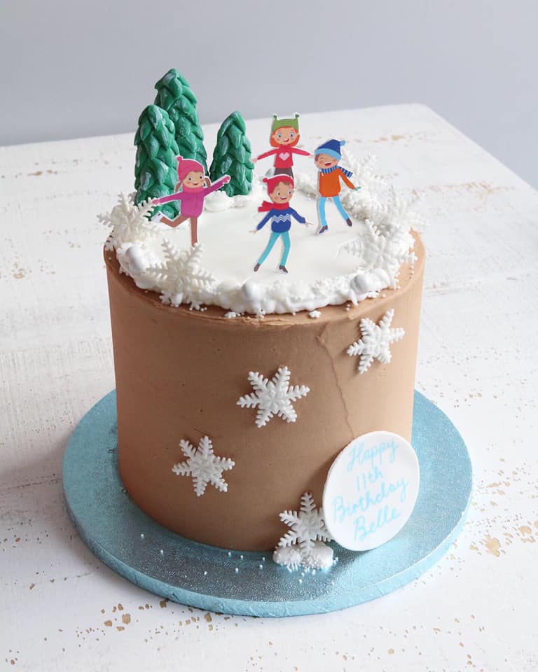 Ice Skating Themed Birthday Cake with Ice Skating Figures, Trees and Snowflakes