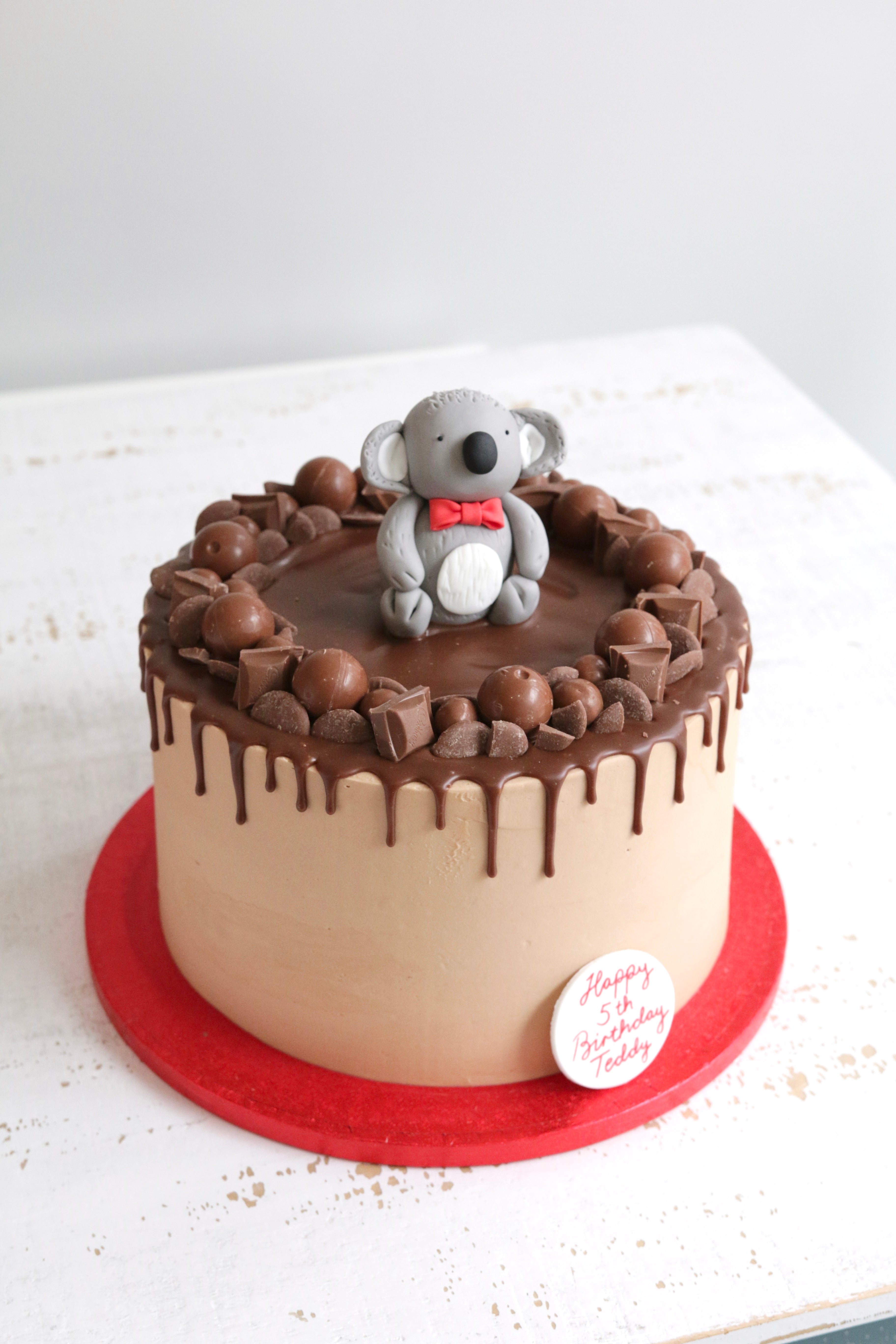 Chocolate Drip Cake with Koala in a Red Bow Tie