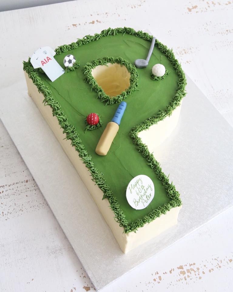 Green Buttercream Letter P Cake with Sports Decorations - Cricket Bat and Ball, Gold Club and Ball and Football Shirt and Ball