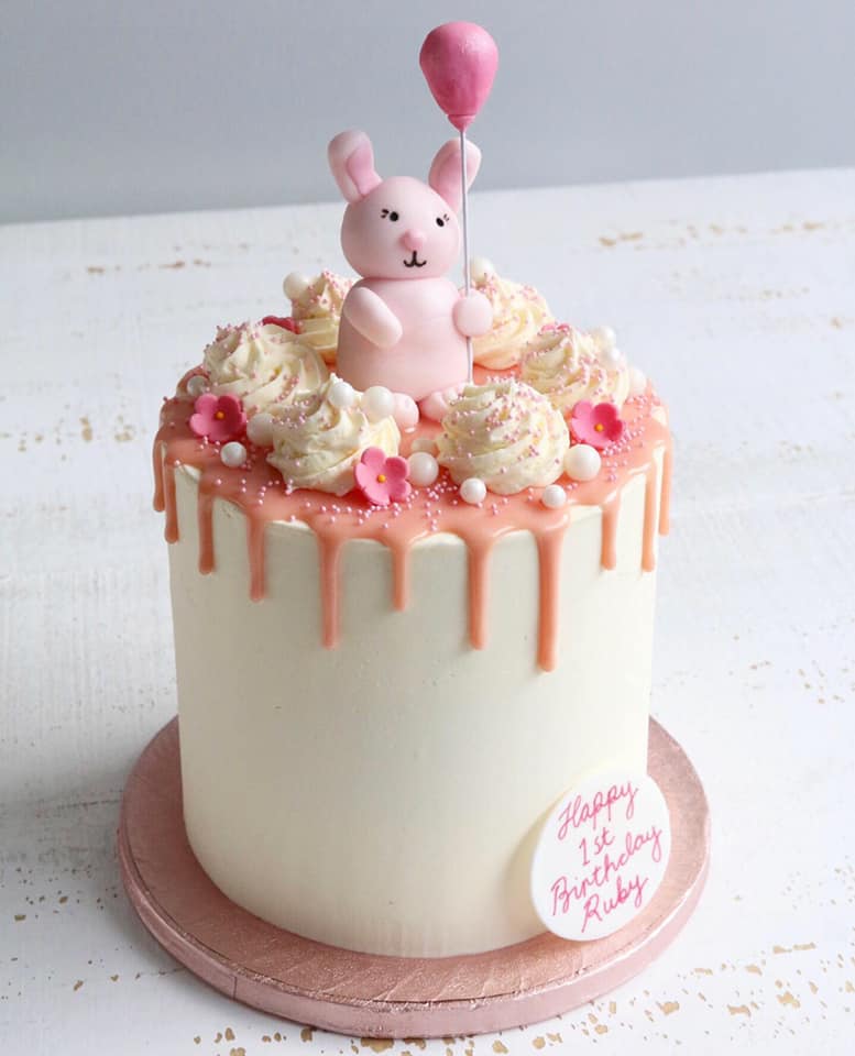 1st Birthday Cake with Pink Drip and Pink Bunny holding a Pink Balloon