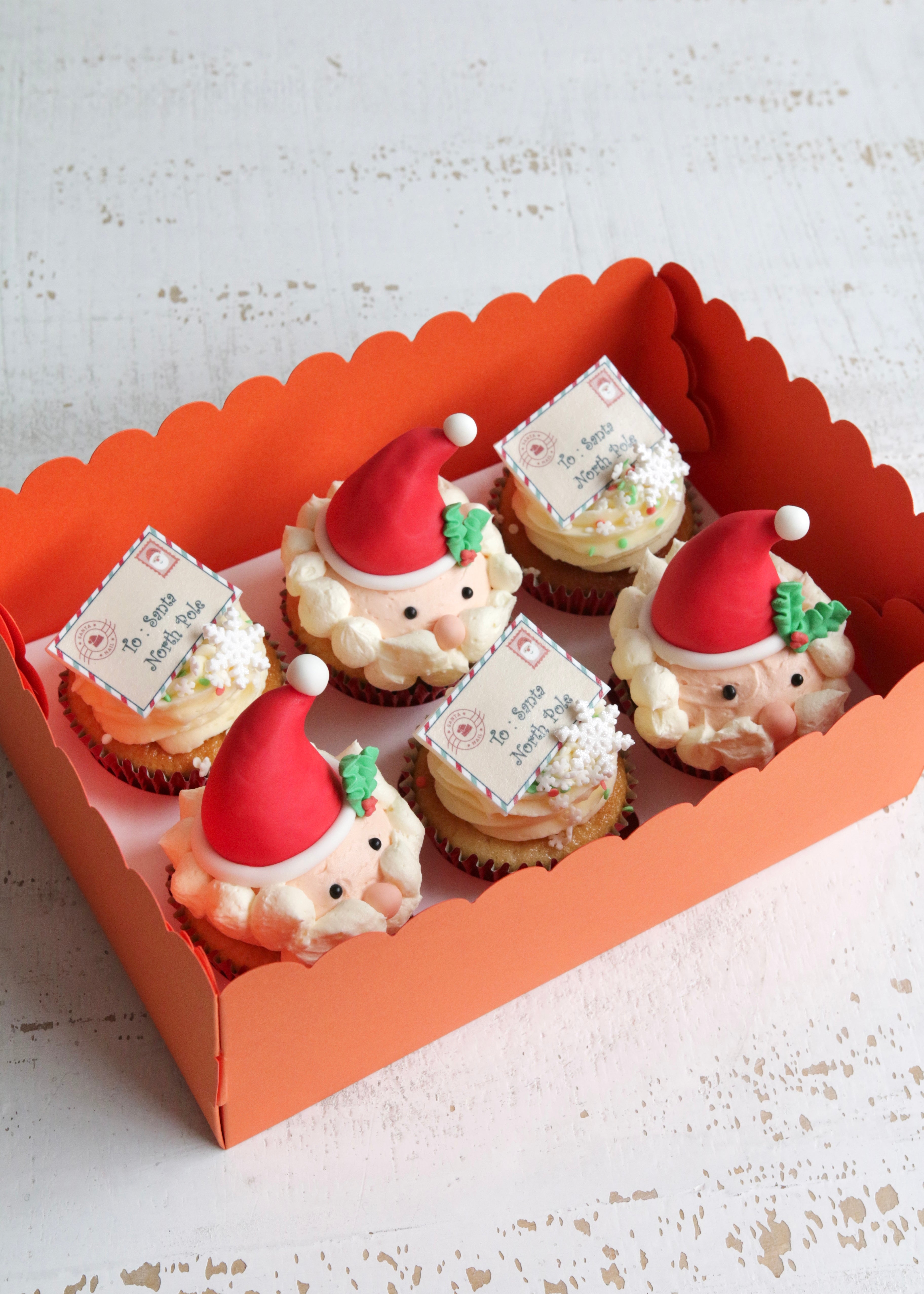 Box of Cupcakes with Santa Head Decorations and Printed Letters To Santa