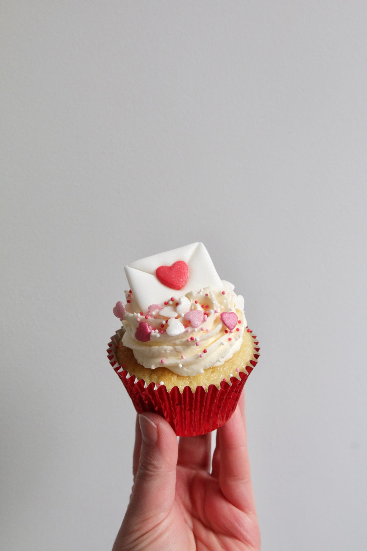 Holding Valentine's Love Letter Cupcake