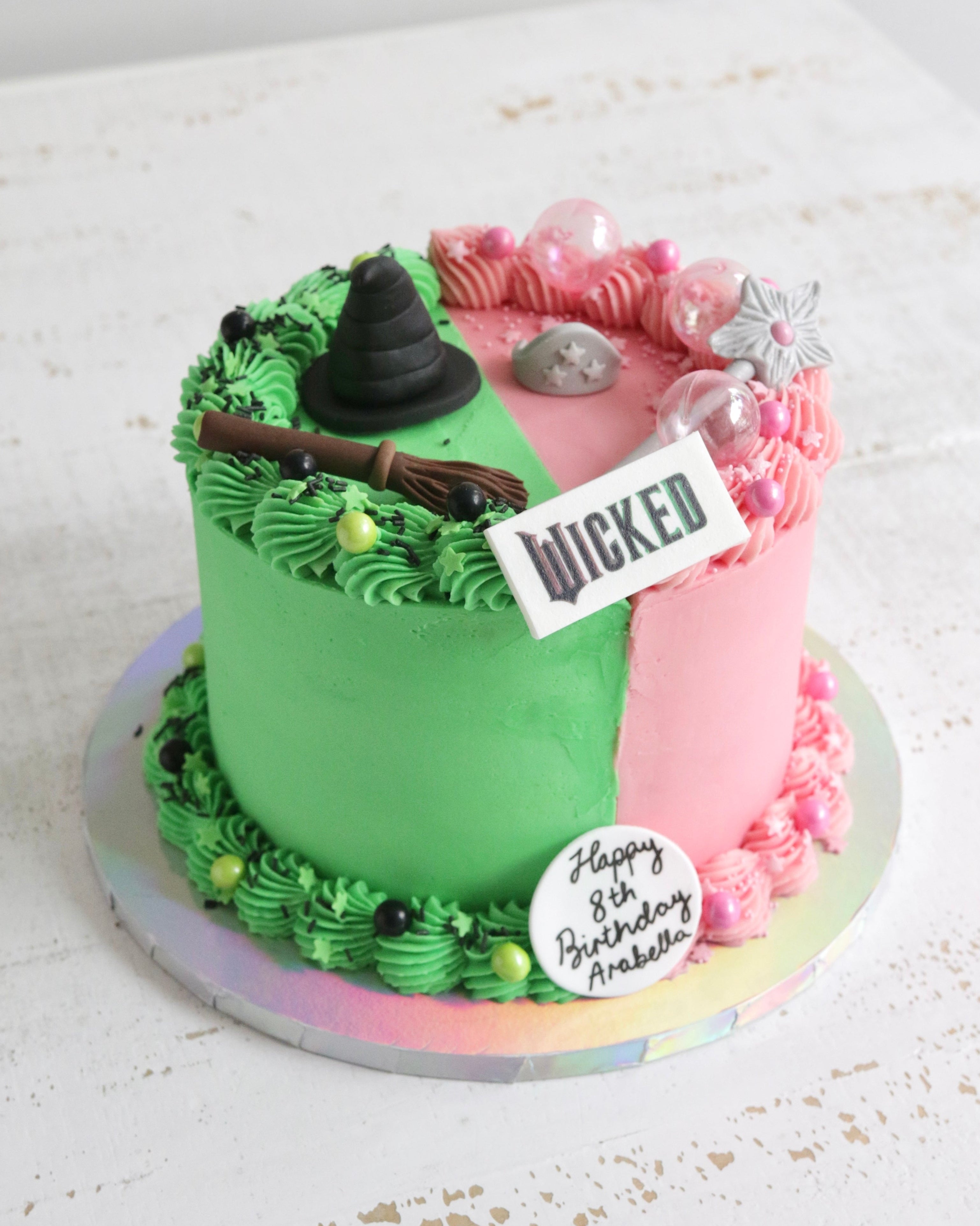 Half Pink and Half Green Buttercream Wicked Musical Cake