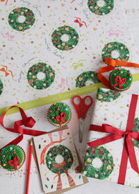 Christmas Wreath Wrapping Paper Flat Lay with Card and Cupcakes