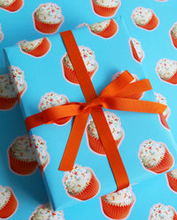 Orange Cupcake Birthday Wrapping Paper tied with Orange Ribbon At an angle