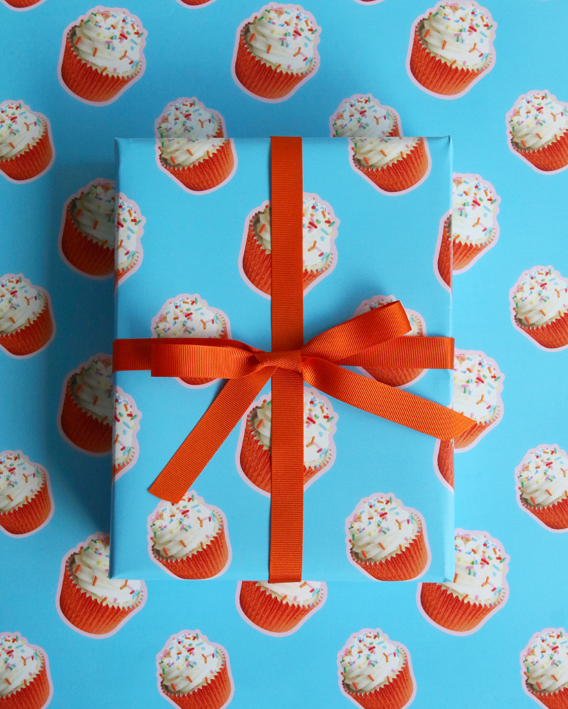 Orange Cupcake Birthday Wrapping Paper tied with Orange Ribbon