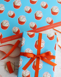 Orange Cupcake Birthday Wrapping Paper with Logo Line tied with Orange Ribbon