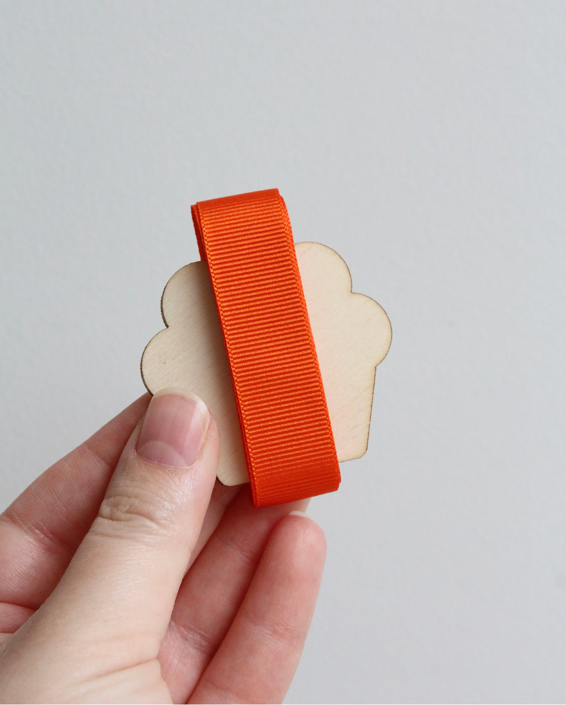 Orange grosgrain ribbon on wooden cutout cupcake