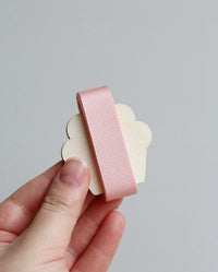 Pale pink grosgrain ribbon on wooden cutout cupcake