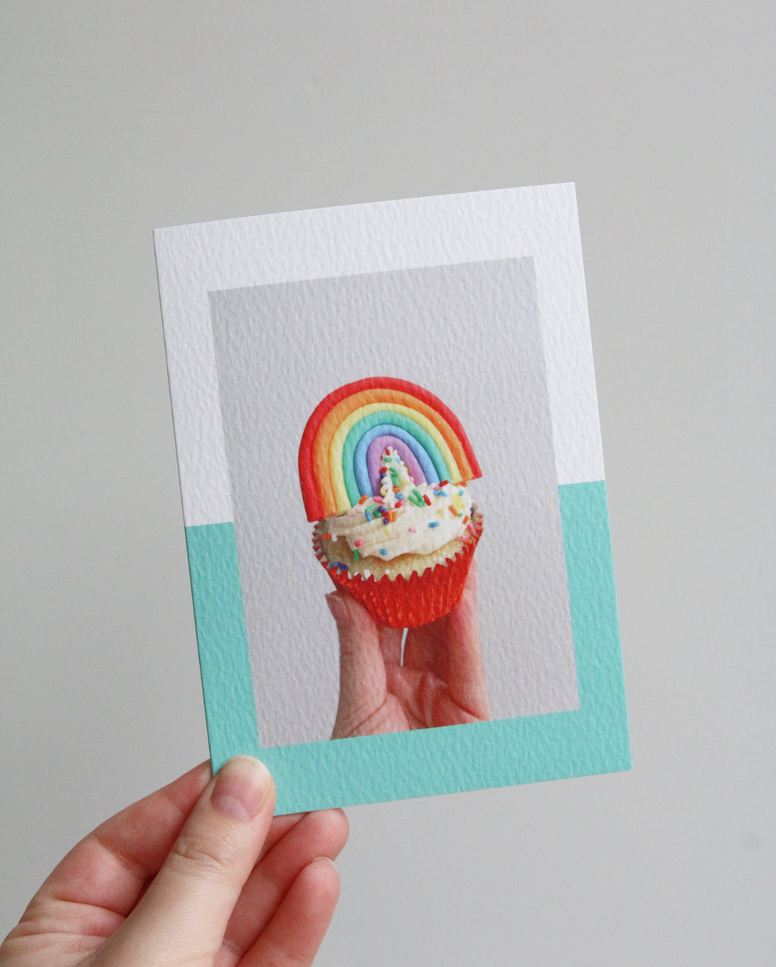 Birthday card with a photo of a cupcake with sprinkles and a fondant rainbow on top