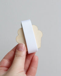 White grosgrain ribbon on wooden cutout cupcake