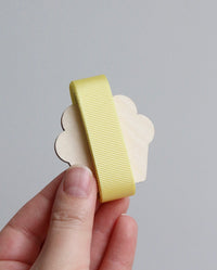 Yellow grosgrain ribbon on wooden cutout cupcake
